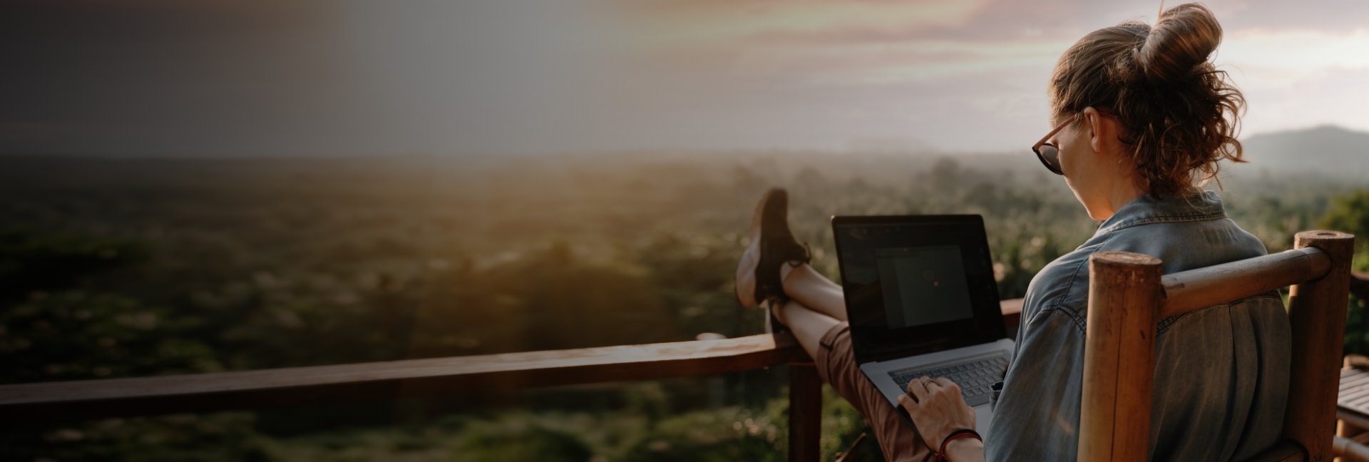 Girl sitting on balcony with Laptop