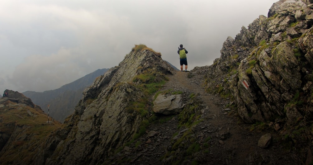 Boy at mountain clicking pictures