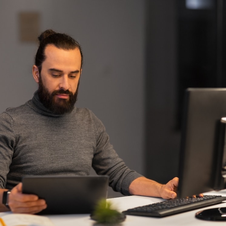 Men with laptop and desktop
