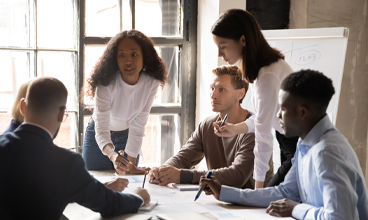 Multicultural business professionals meeting to discuss performance measurement